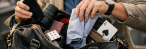 Homme élégant sortant plusieurs objets d’un sac, symbole de l’expression avoir plus d’un tour dans son sac
